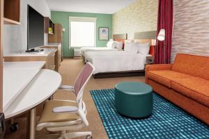 舒格兰Home2 Suites By Hilton Sugar Land Rosenberg的配有床和沙发的酒店房间