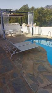 uma piscina com mesa e cadeiras ao lado em Tropical Suite em Benalmádena