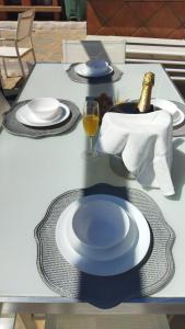 a table with two plates and a bottle of champagne at Tropical Suite in Benalmádena