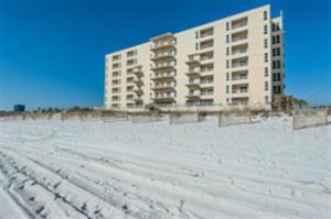 a large building on the beach in the snow at Sans Souci 303 in Pensacola Beach