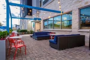 a patio with tables and chairs and lights at Tru By Hilton Cypress Houston TX in Cypress