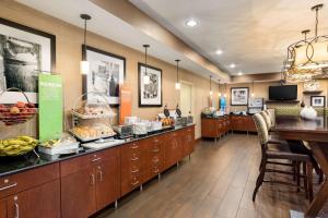 a cafeteria with a buffet line with fruit on display at Hampton Inn Wichita-East in Wichita