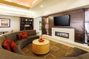 a living room with a couch and a fireplace at Homewood Suites by Hilton Lawton in Lawton