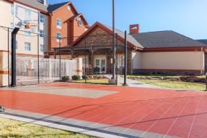 a basketball court in front of a house at Homewood Suites by Hilton Lawton in Lawton