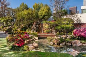 a garden with a pond and flowers at Doubletree by Hilton Los Angeles Downtown in Los Angeles