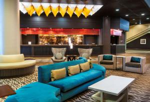 a lobby with a blue couch and chairs at Doubletree by Hilton Los Angeles Downtown in Los Angeles