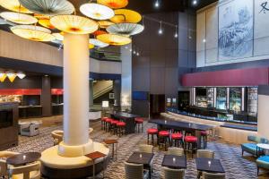 a lobby with tables and chairs and umbrellas at Doubletree by Hilton Los Angeles Downtown in Los Angeles