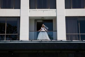 a woman in a wedding dress standing on a balcony at Doubletree by Hilton Los Angeles Downtown in Los Angeles