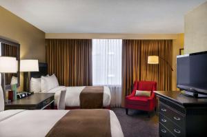 a hotel room with two beds and a flat screen tv at Doubletree by Hilton Los Angeles Downtown in Los Angeles