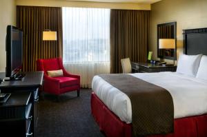 a hotel room with a bed and a desk and a chair at Doubletree by Hilton Los Angeles Downtown in Los Angeles