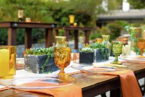 a wooden table with plates and glasses on it at Doubletree by Hilton Los Angeles Downtown in Los Angeles