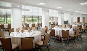 a banquet room with tables and chairs with white tablecloths at Doubletree by Hilton Los Angeles Downtown in Los Angeles