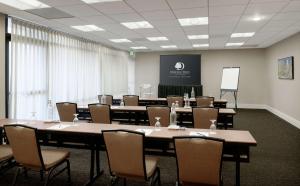 a conference room with tables and chairs and a whiteboard at Doubletree by Hilton Los Angeles Downtown in Los Angeles