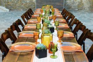 a long table with plates and wine glasses on it at Doubletree by Hilton Los Angeles Downtown in Los Angeles