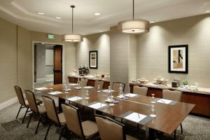 a conference room with a large wooden table and chairs at Doubletree by Hilton Los Angeles Downtown in Los Angeles