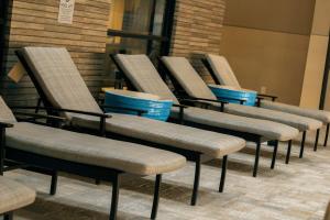 a row of chairs lined up against a wall at Doubletree By Hilton Lubbock - University Area in Lubbock