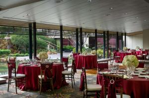 a room with tables and chairs with red table cloths at Doubletree by Hilton Los Angeles Downtown in Los Angeles