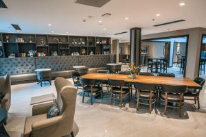 a dining room with a large wooden table and chairs at Doubletree By Hilton Lubbock - University Area in Lubbock