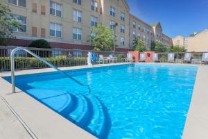 a swimming pool with blue water in a building at Homewood Suites by Hilton Southwind - Hacks Cross in Memphis