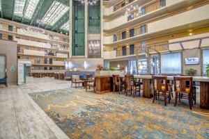 a hotel lobby with a bar and tables and chairs at Embassy Suites Memphis in Memphis