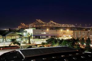 a night view of a large building with a roller coaster at Hilton Garden Inn New Orleans Convention Center in New Orleans