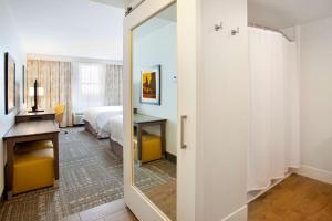 a bathroom with a door leading to a bedroom at Hampton Inn & Suites - Minneapolis/Downtown in Minneapolis