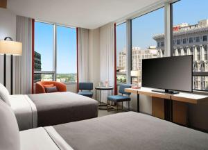 Cette chambre comprend 2 lits et une télévision à écran plat. dans l'établissement Canopy by Hilton New Orleans Downtown, à La Nouvelle-Orléans