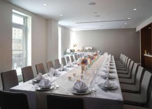 a long long table in a room with chairs at Canopy by Hilton New Orleans Downtown in New Orleans