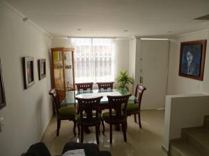 a dining room with a table and chairs at Casa tranquila in Mosquera +10 photos