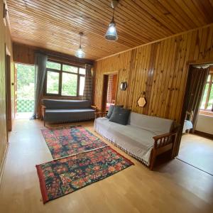 a bedroom with a bed and a couch in a room at Nanus Ayder Apart and Restoran in Rize