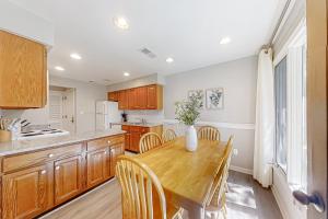 a kitchen with a wooden table and wooden cabinets at Turtle Cove 5546 in Kiawah Island