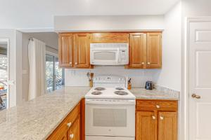 a kitchen with a stove and a microwave at Turtle Cove 5546 in Kiawah Island +22 photos