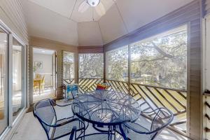 a dining room with a table and chairs on a balcony at Turtle Cove 5546 in Kiawah Island