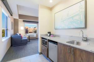 a kitchen with a sink and a couch in a room at Hampton Inn & Suites Pittsburgh Downtown in Pittsburgh