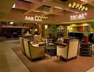 a lobby with chairs and a bar in a hotel at DoubleTree by Hilton Pittsburgh - Meadow Lands in Washington