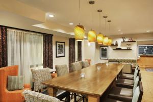 a dining room with a wooden table and chairs at Hampton Inn Shawnee in Shawnee