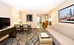 a living room with a couch and a dining room at Embassy Suites by Hilton Seattle Bellevue in Bellevue