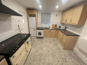 a small kitchen with a sink and a stove at Joyous Private Room in City Centre in Liverpool