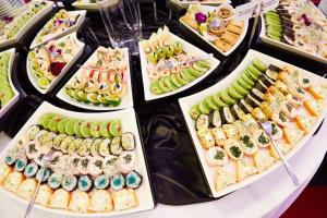 a buffet of sushi and other food on a table at Hotel Novum & Spa in Niepołomice