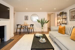a living room with a couch and a table at Be London - The St John's Wood Residences in London