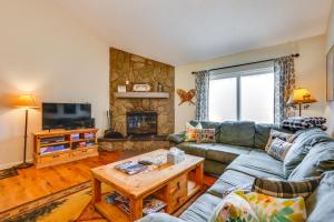 a living room with a couch and a table at Family-Friendly Fraser Condo with Heated Pool Access in Fraser