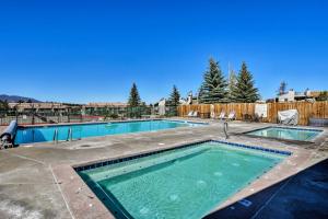 a large swimming pool in a yard at Family-Friendly Fraser Condo with Heated Pool Access in Fraser