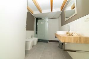 a bathroom with a sink and a toilet at La Casetta 117 in Cagliari