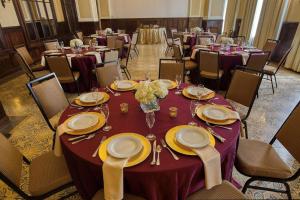 a banquet hall with tables and chairs with purple table cloth at Hampton Inn & Suites Bradenton in Bradenton