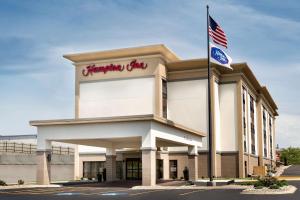 a building with an american flag in front of it at Hampton Inn St. Joseph in Saint Joseph