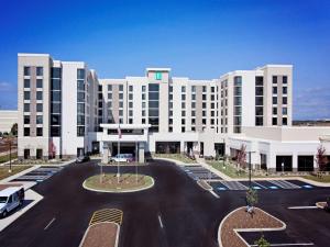 a large white building with a parking lot at Embassy Suites By Hilton Syracuse Destiny USA in Syracuse