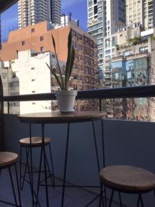 a table with a potted plant on a balcony at Departamento en Palermo Parking included in Buenos Aires