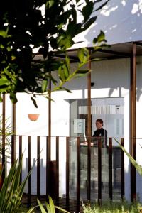 a man standing at a counter in a building at Hotel Boutique Ses Pitreras in San Antonio Bay