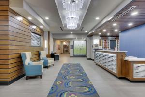 a lobby of a hospital with chairs and a rug at Hampton Inn & Suites Tyler-South in Tyler