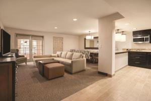 a large living room with a couch and a kitchen at Homewood Suites Tucson St. Philip's Plaza University in Tucson